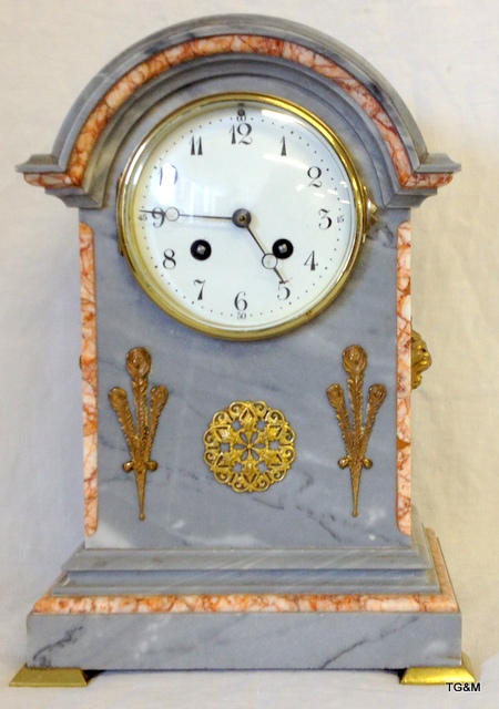 Good marble mantle clock with arched top the case inset with fleur-de-ly`s and lion mask handles