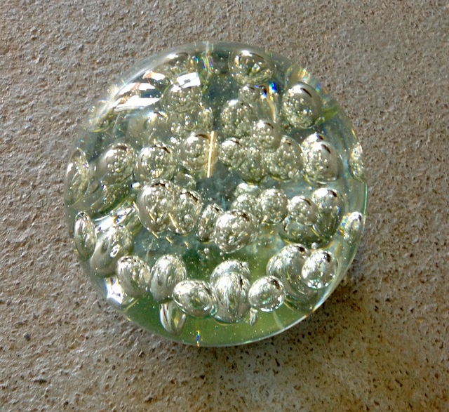 A large glass bubble paperweight