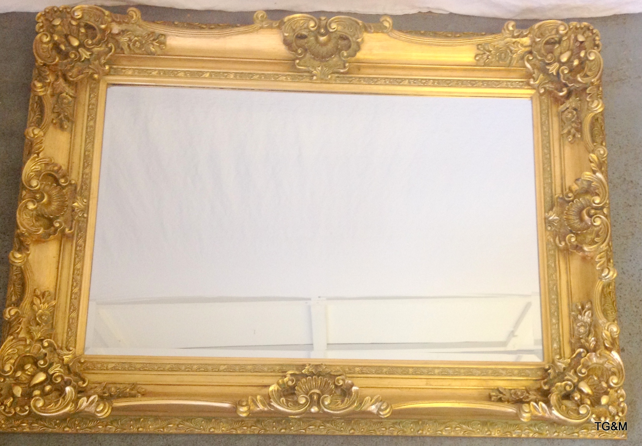 Swept gold coloured framed mirror 120 x 90cm