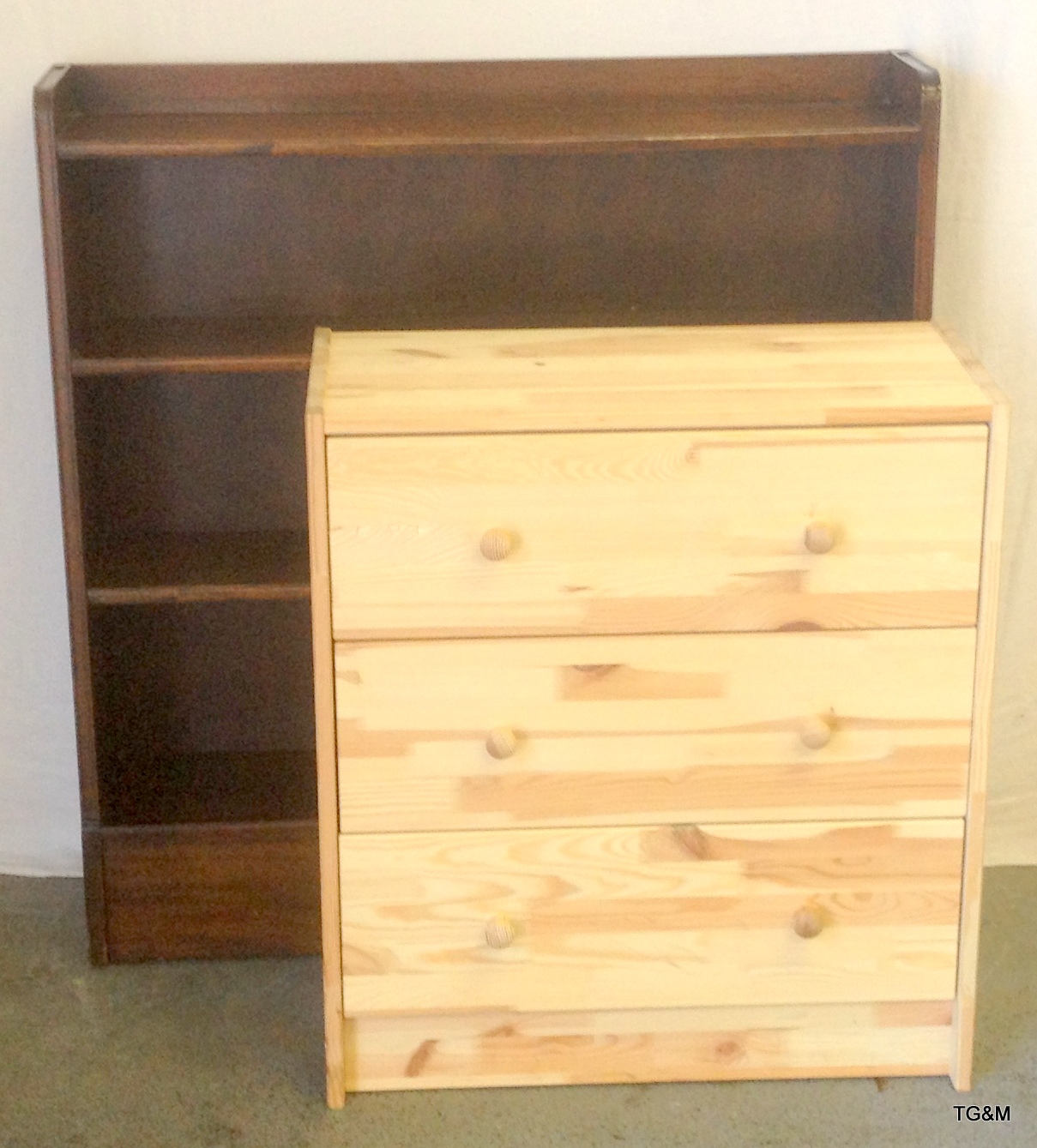 A mahogany bookcase and a pine chest of drawers