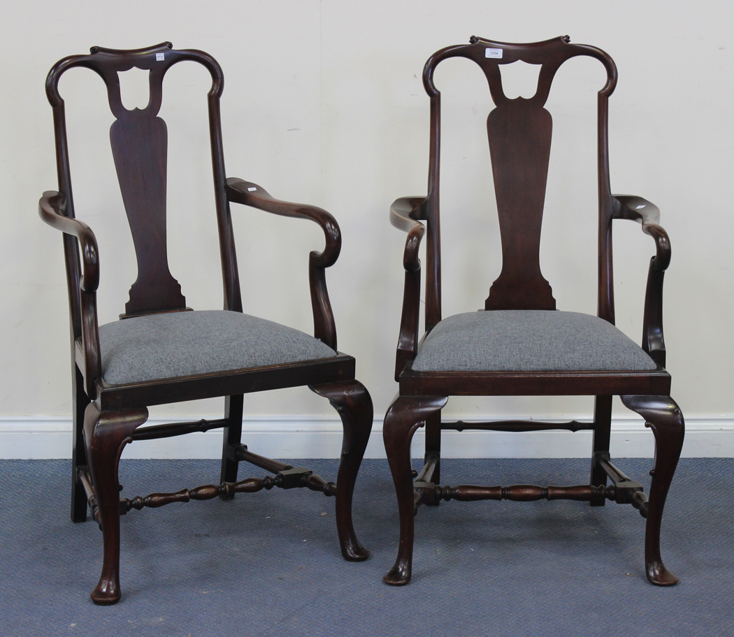A pair of early 20th Century Queen Anne style mahogany pierced vase back elbow chairs with