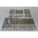A set of twelve silver handled Thread and Shell pattern table and dessert knives, Sheffield 1975,
