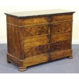 A late 19th Century French walnut commode, the black marble top above four drawers, flanked by