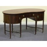 An early 20th Century mahogany kidney shaped writing desk, the top inset with claret leather above a