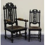 A set of six Victorian Carolean Revival oak dining chairs with carved and pierced splat backs,