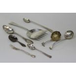 A Victorian silver sifter spoon with floral medallion embossed and pierced bowl, the scroll handle