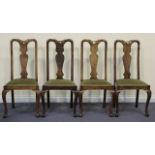 A set of four early 20th Century Queen Anne style walnut splat back dining chairs with drop-in