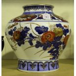 A Japanese Imari porcelain vase of baluster form, painted and gilt with chrysanthemums and leaves,