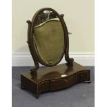 A George III mahogany oval swing frame toilet mirror with boxwood line inlaid decoration, the