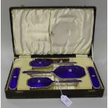 A silver and blue enamelled five piece dressing table set, each top mounted with a crown, comprising