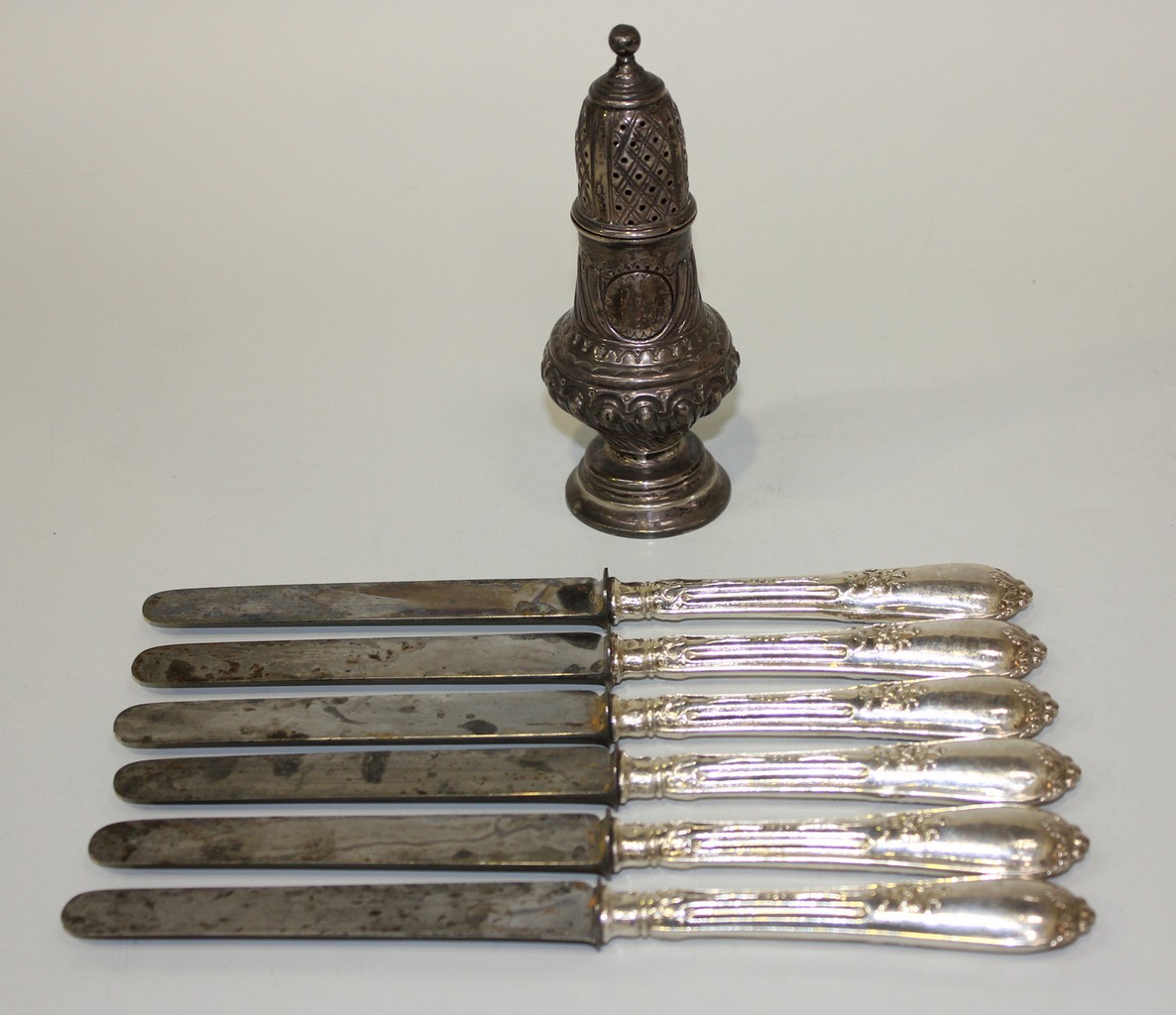 A late Victorian silver pepper caster, of spiral reeded baluster form with pierced dome cover,