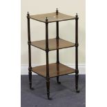 A Victorian mahogany three-tier whatnot with turned supports and finials, on brass caps and castors,