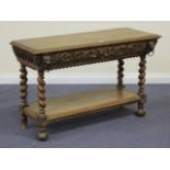 A late Victorian oak side table, the single frieze drawer carved with birds and scrolls, on barley