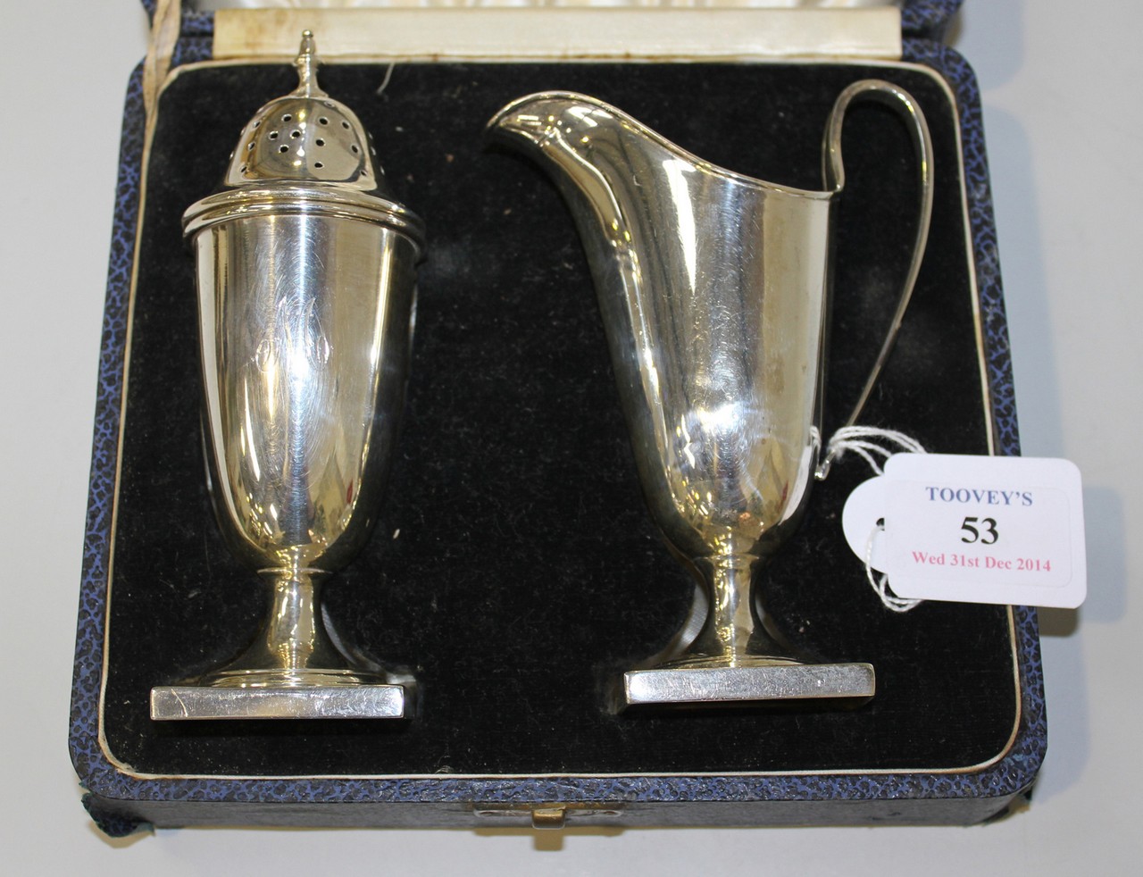 A silver cream jug and matching sugar caster, each of 'U' shaped form, on a square base, Sheffield