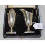 A silver cream jug and matching sugar caster, each of 'U' shaped form, on a square base, Sheffield