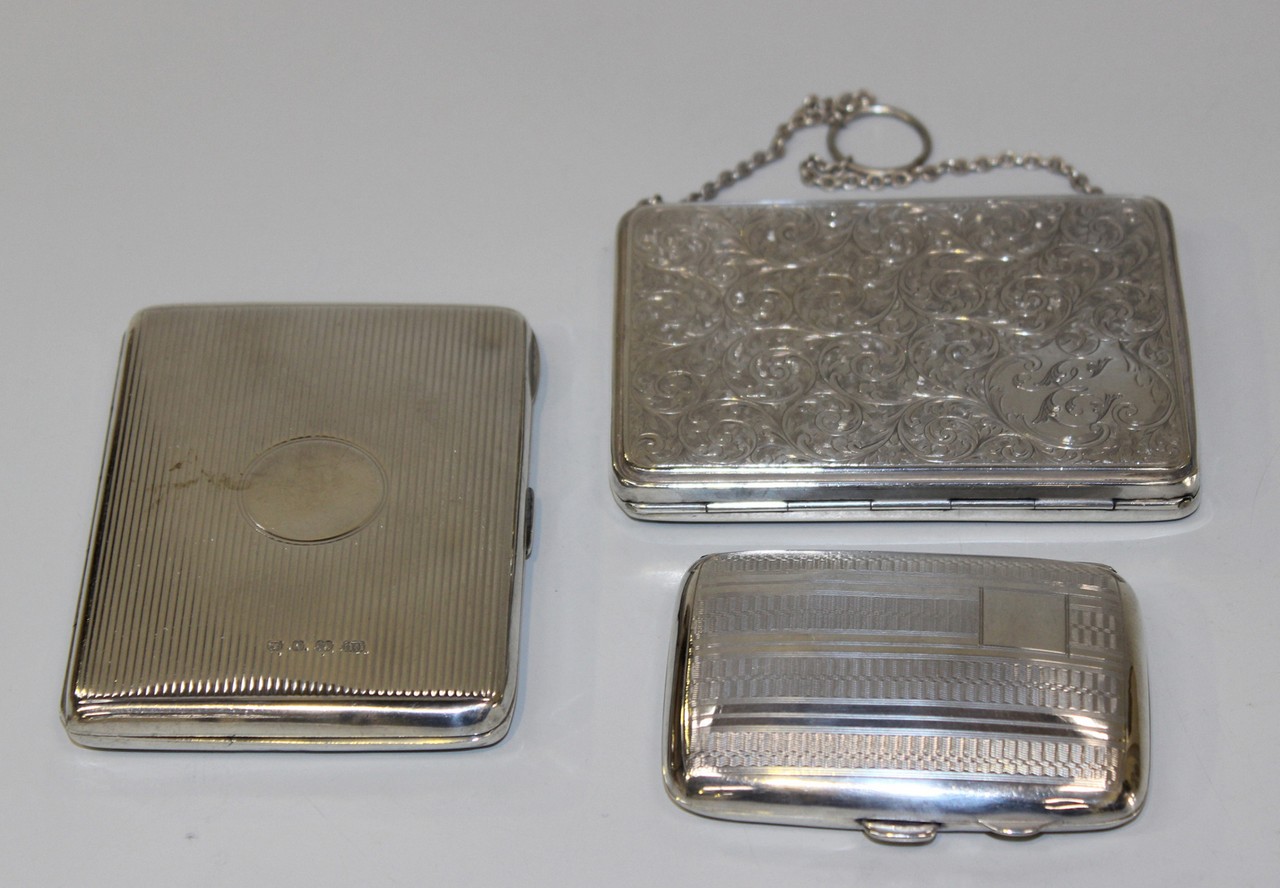 A George V silver cigarette case with overall foliate scroll engraved decoration, Birmingham 1913 by
