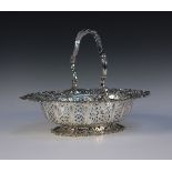 A Victorian silver oval cake basket, the overhead scroll handle cast with lattice panels and