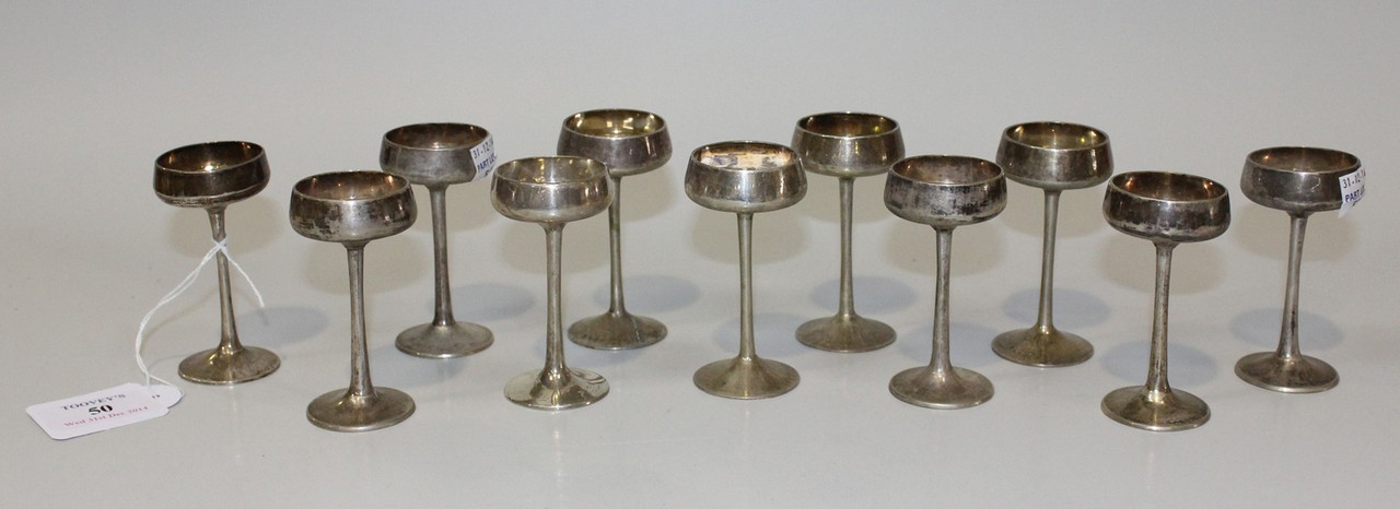 A set of eleven Chinese silver liqueur goblets, each circular bowl on a slender stem and circular