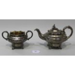 A William IV silver teapot and matching two handled sugar bowl, each of circular ogee form, embossed