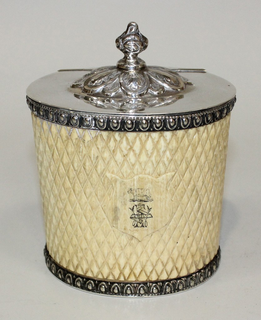 A mid-Victorian carved ivory and plate mounted tea caddy of oval section, the hinged lid with a