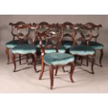 A set of eight early Victorian rosewood dining chairs, each with a carved scroll open back above