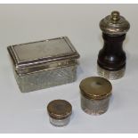 A silver mounted turned wood pepper mill, London 1984, a rectangular cut glass dressing table box