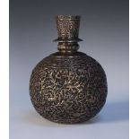 An Indian Mughal style white metal hookah base, the globular body finely worked in relief with a