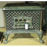 An early 20th Century French green enamelled wood burner by Godin, raised on cabriole legs, height