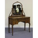 An early 20th Century Australian walnut dressing table, fitted with a swing mirror above five