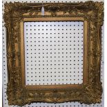 A 19th Century Rococo Revival gilt composition picture frame with shell and foliate scroll