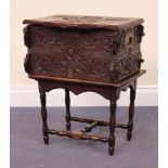 A Victorian oak box, dated 1898, the hinged lid and sides inlaid in brass and carved with foliate