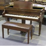 An Art Deco mahogany cased baby grand piano by Strohmenger, overstrung, the frame bearing 'Regd