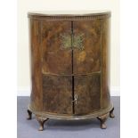 A 20th Century Queen Anne style walnut drinks cabinet, the moulded top above a mirrored interior,