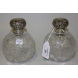A pair of late Victorian silver topped cut glass globular scent bottles and stoppers, each silver