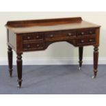 An early Victorian mahogany lady's writing table, the moulded top above an arrangement of five