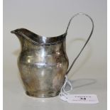 A George III silver cream jug with reeded loop handle and rim, London 1802 by John Merry, height
