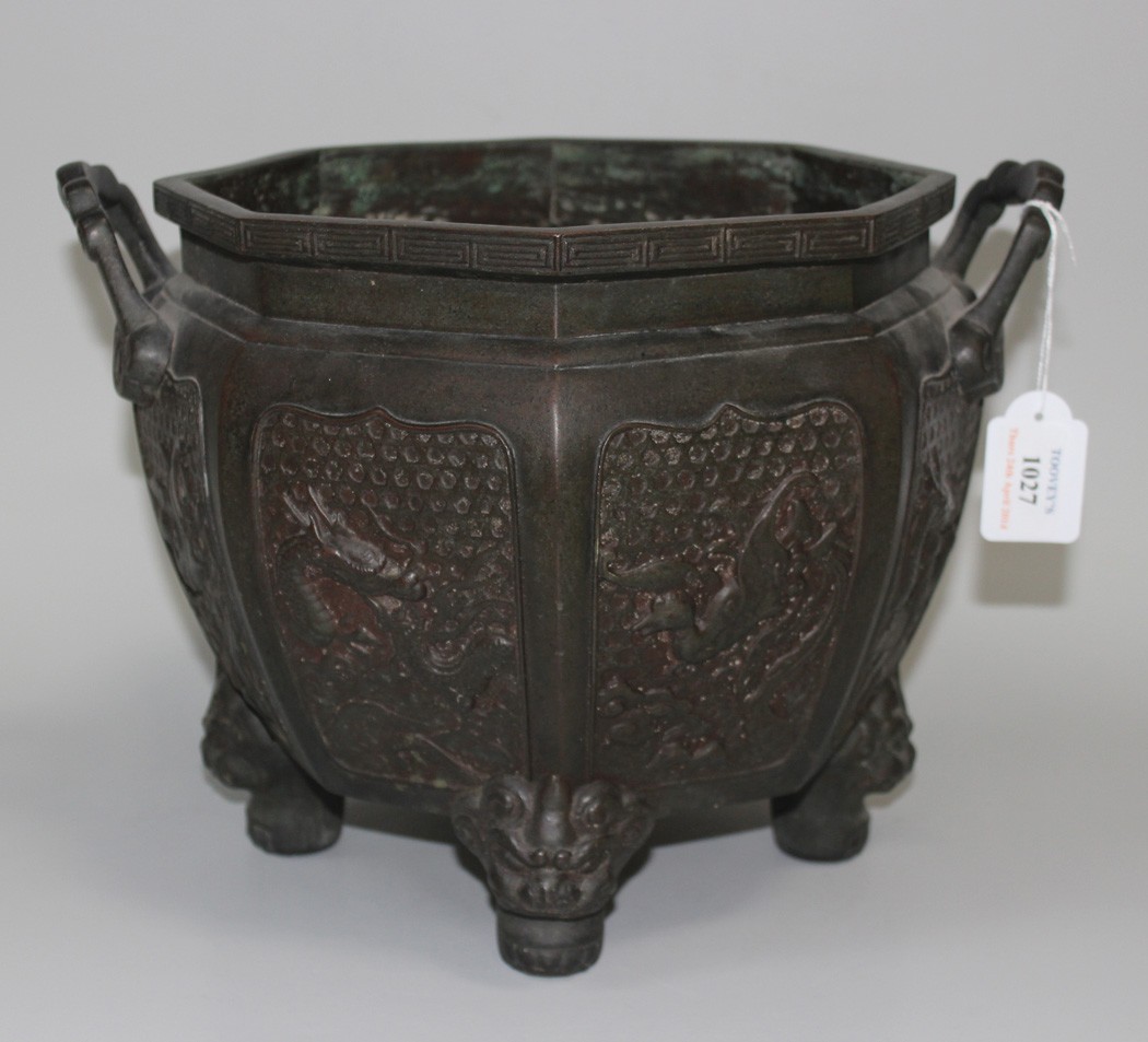 A Chinese brown patinated bronze octagonal jardinière, early 20th Century, each side cast in