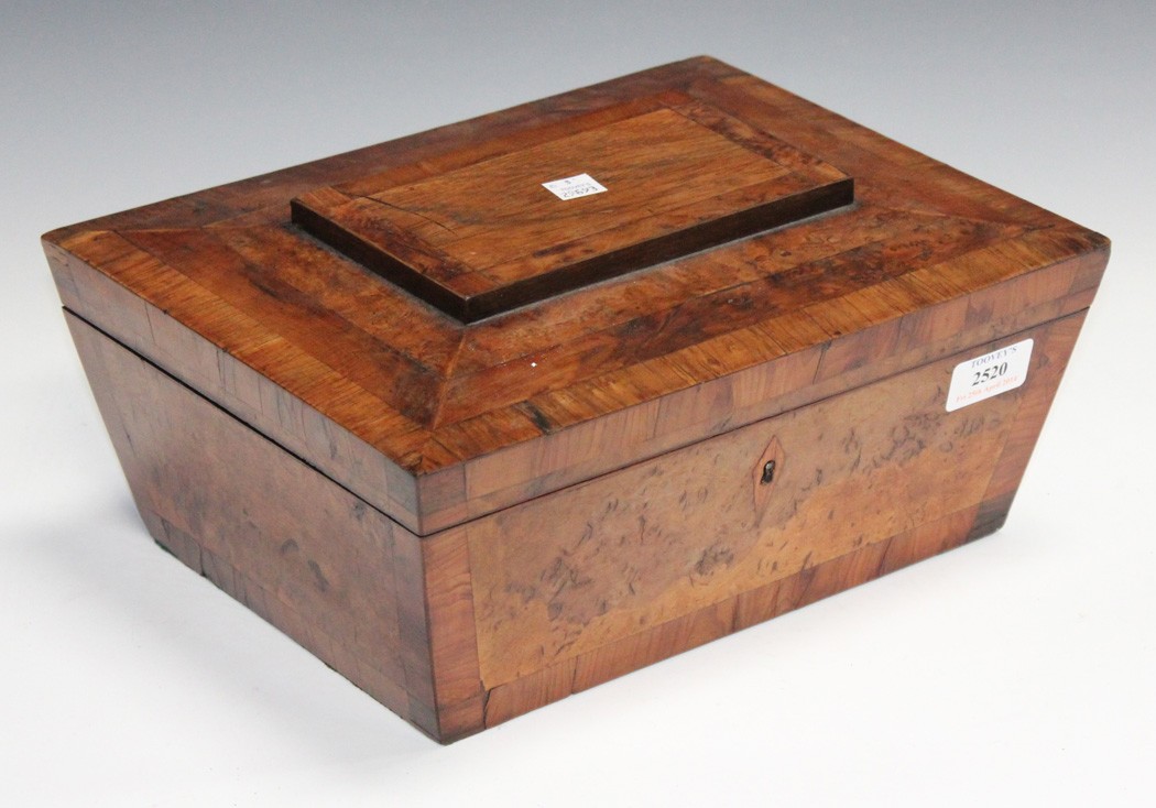 A Regency pollard oak and yew banded sewing box of sarcophagus form, the hinged lid revealing a