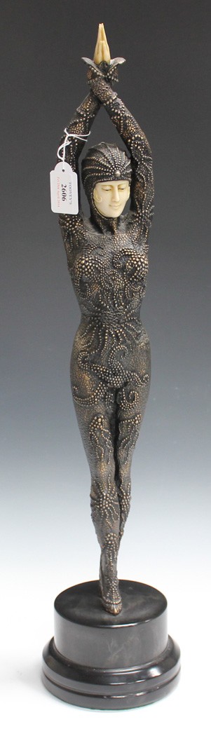 A late 20th Century Art Deco style resin figure of a dancer holding a stylish pose, raised on a