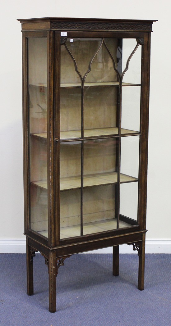 A George V mahogany display cabinet, the blind fretwork frieze above an astragal glazed door, on