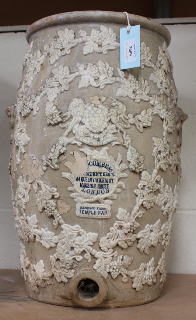 A Victorian salt glazed stoneware urn with overall sprigged vine leaves and royal coat of arms,