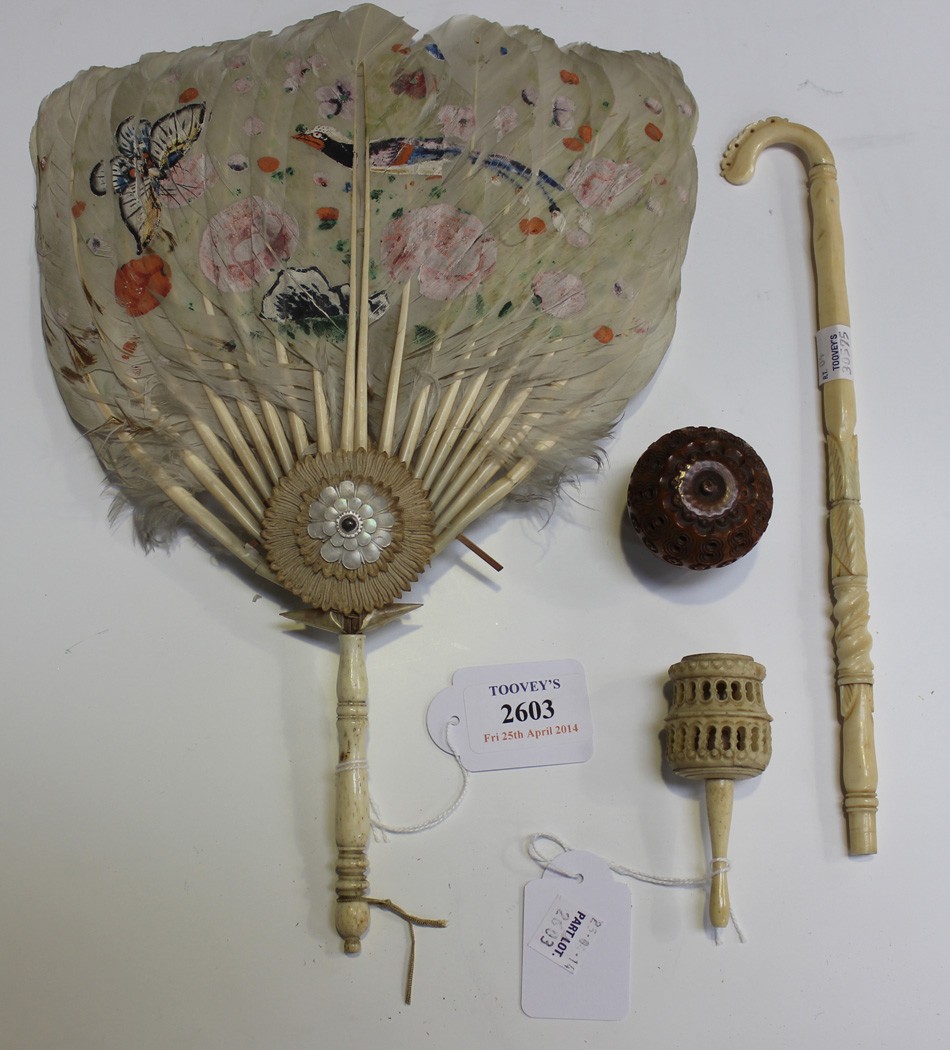 A 19th Century carved ivory parasol handle, a bone handled feather fan, a 19th Century bone child`