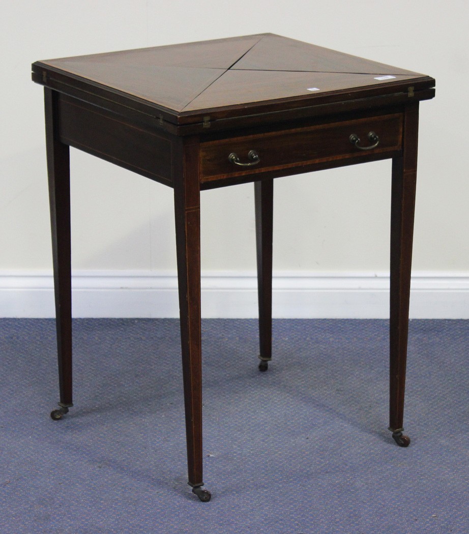 An Edwardian mahogany envelope card table with satinwood banding and boxwood stringing, fitted