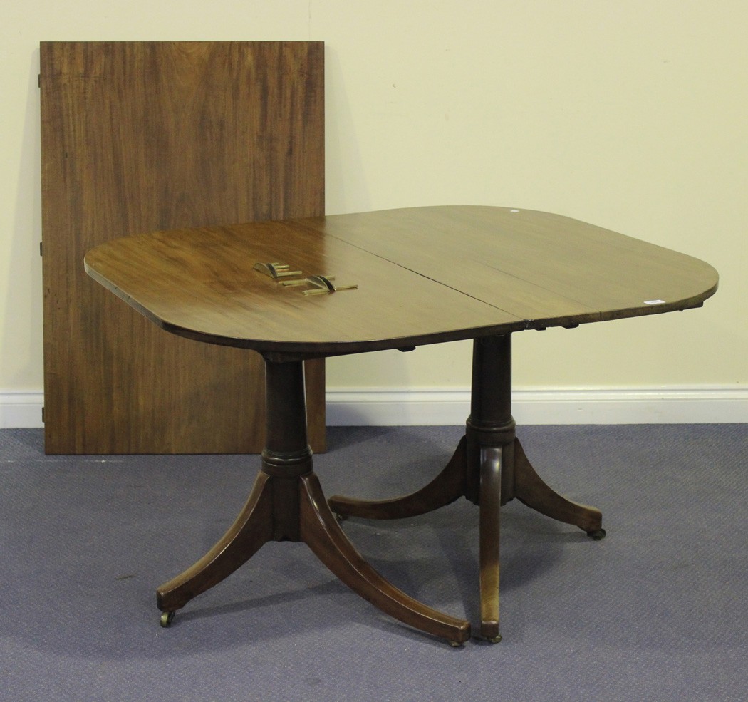 An early 19th Century and later mahogany `D` end dining table, the top with a single extra leaf,