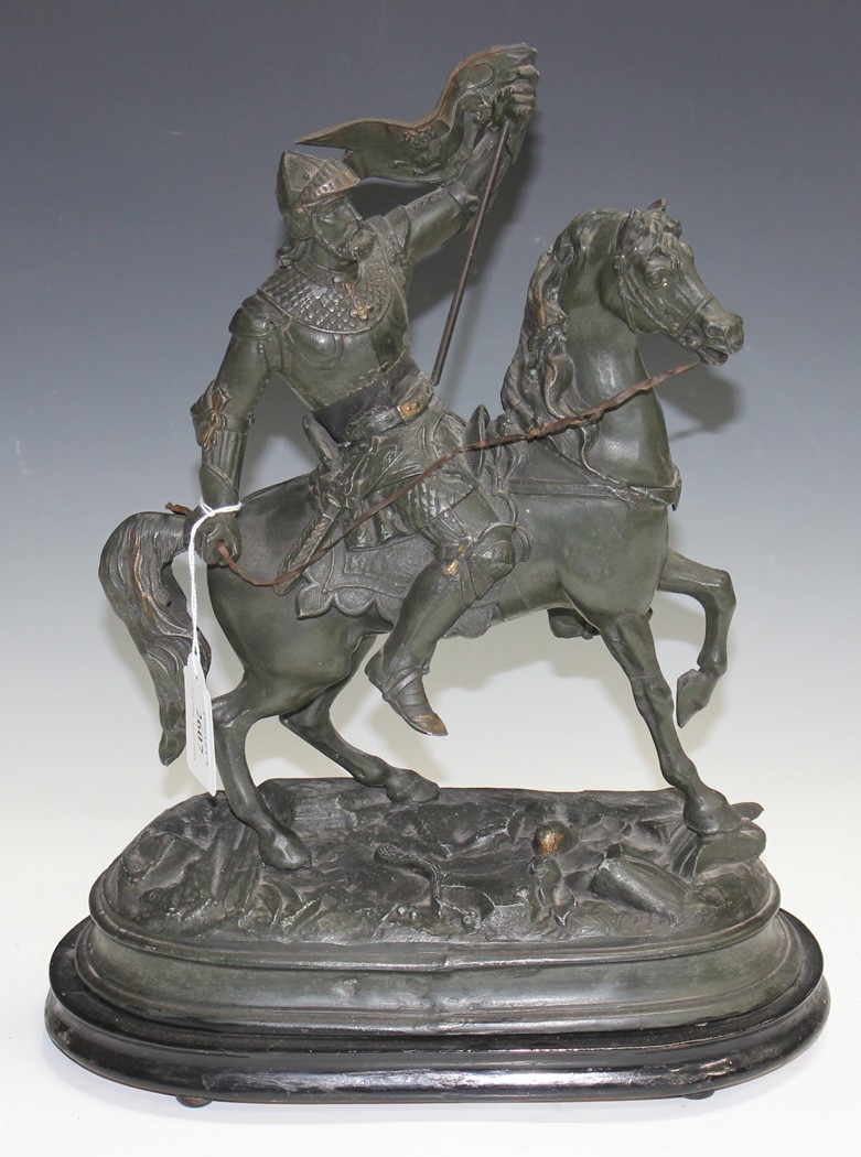 A late 19th Century spelter figure of a knight on horseback, on an ebonized oval plinth base, height