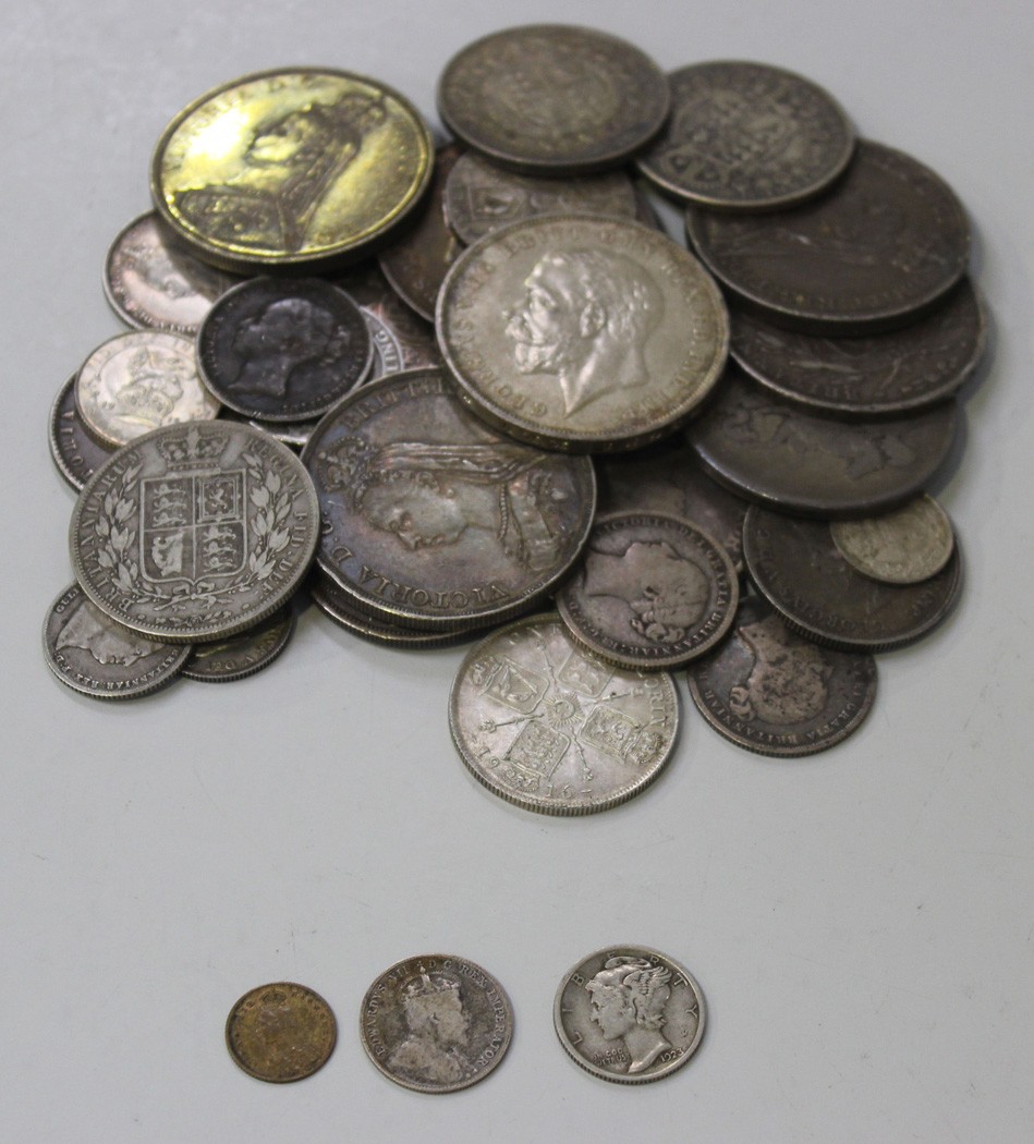 A collection of British coins, comprising a George IV crown 1821 (has been brooch mounted), a