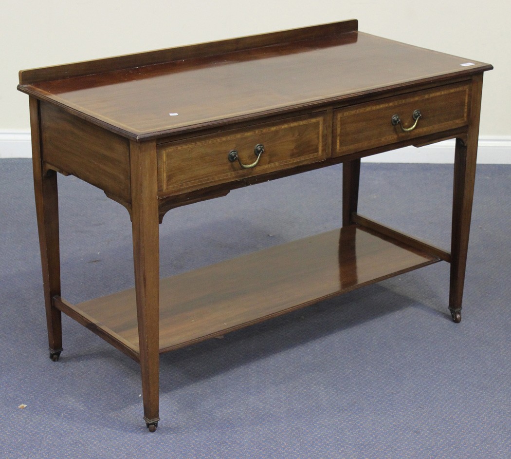 An Edwardian mahogany side table fitted with two frieze drawers, on square tapering legs, united