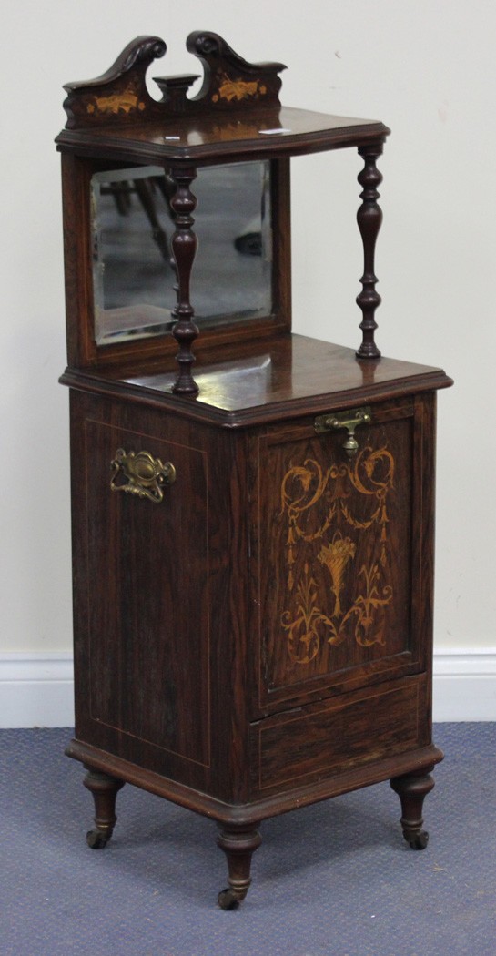 A late Victorian rosewood coal purdonium with foliate inlaid decoration, the mirrored shelf back