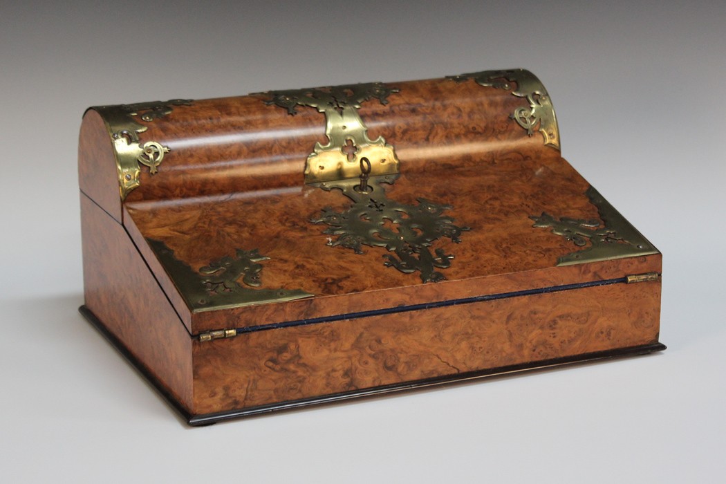 An early Victorian Gothic Revival burr walnut writing box with overall applied brass strapwork