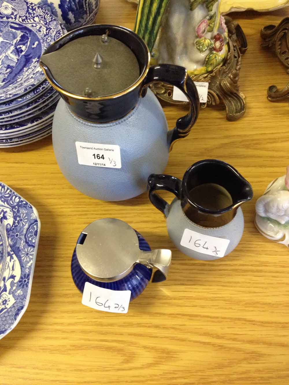 2 stoneware jugs and a smaller ceramic jug.